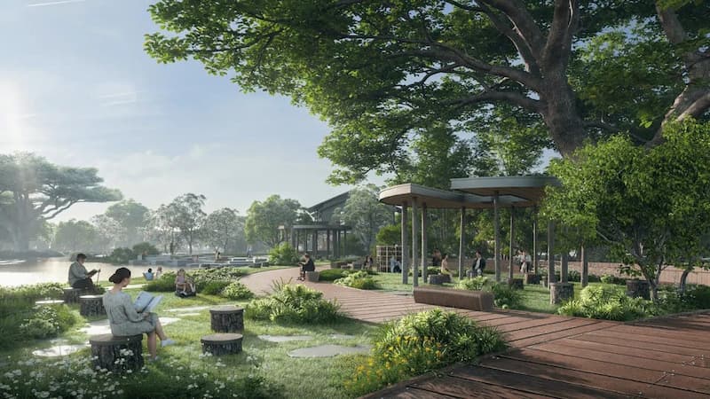 Thư giãn giữa thiên nhiên tại Công viên ven sông tại Alluvia City, nơi cư dân tận hưởng không gian yên bình, ghế ngồi tự nhiên và cảnh quan xanh mát.